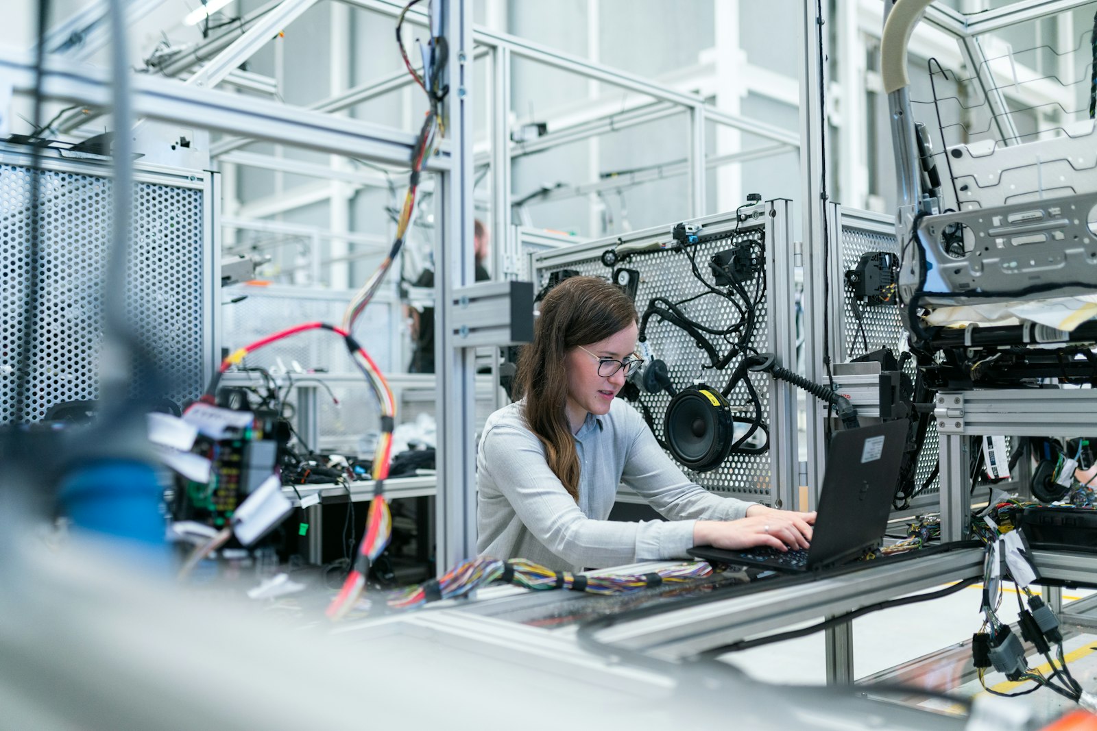 Engineer configuring equipment from her laptop in a technical environment