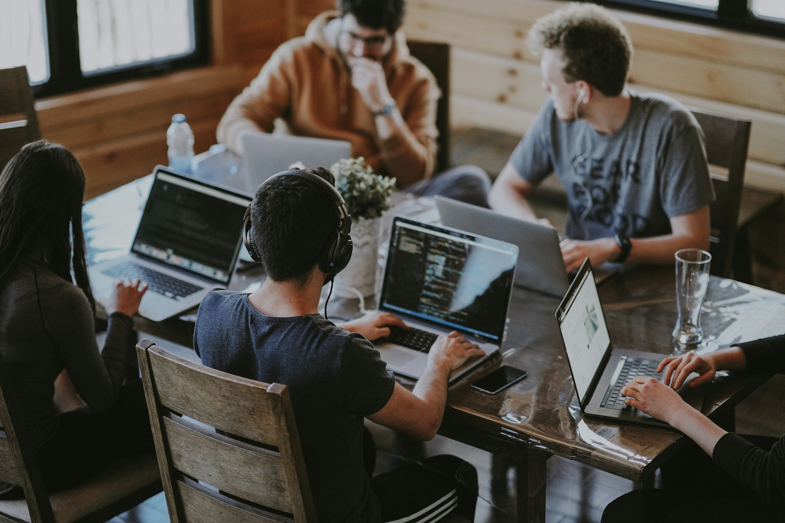Technical team working together across several workstations